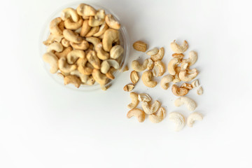 Healthy food  for background image close up cashew nuts.  Nuts texture on white grey table top view on the cup plate