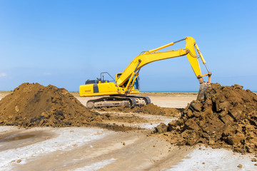 Fototapeta na wymiar Yellow excavator in construction site