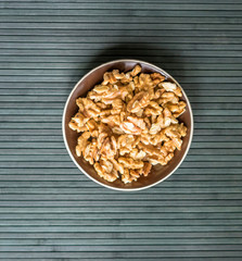 Healthy food  for background image close up walnuts.  Nuts  texture on top view on the cup plate
