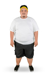 Happy fat man stands with sportswear on studio