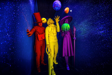 Group of stylized fantasy actors in scenic make-up and bright colored background. 