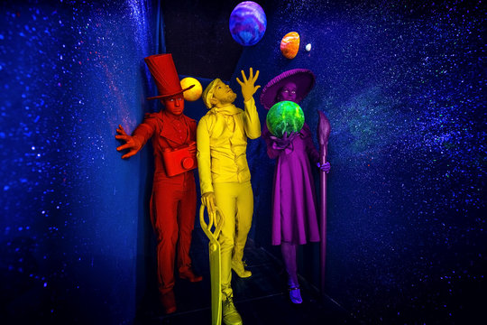 Group of stylized fantasy actors in scenic make-up and bright colored background. 