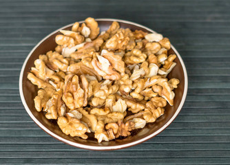 Healthy food  for background image close up walnuts.  Nuts  texture on top view on the cup plate