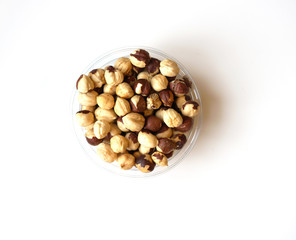 Healthy food  for background image close up hazelnuts.  Nuts texture on white grey table top view on the cup plate
