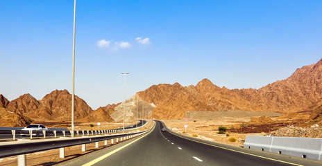 Geological landscape of Jabal Jais characterised by dry and rocky mountains, Road between mud...