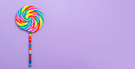 Big lollipop on a purple paper background