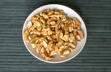 Healthy food  for background image close up walnuts.  Nuts  texture on top view on the cup plate