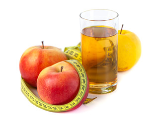 apple and apple juice with tape measure on white background