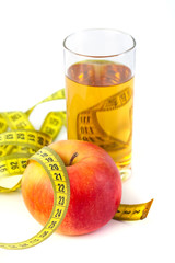 apple and apple juice with tape measure on white background