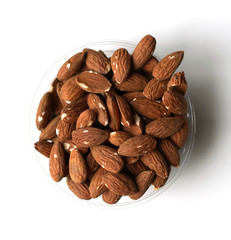 Healthy food  for background image close up almond nuts. Texture on white grey table top view. Nuts on the cup plate