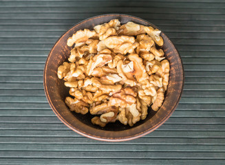 Healthy food  for background image close up walnuts.  Nuts  texture on top view on the cup plate