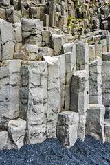 Vertical hexagonal Basalt cliffs in the bottom of Reynisfjall mountain in Southern Iceland.