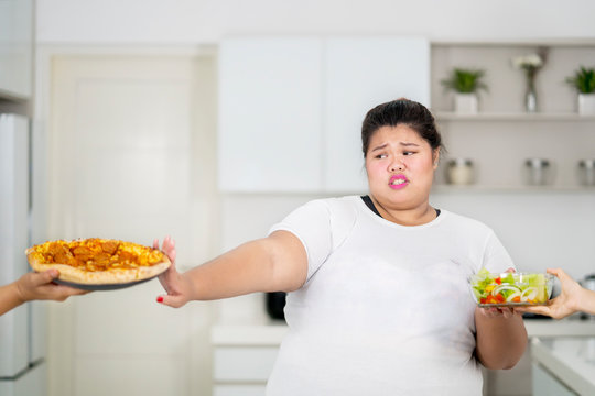 Overweight Woman Refusing To Eat Pizza