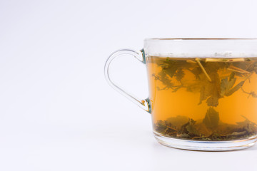 green herbal tea in a transparent cup isolated on white background