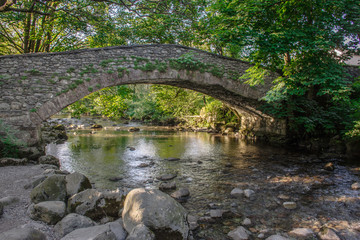 Fototapeta na wymiar Stone bridge over mountain stream in rural UK.