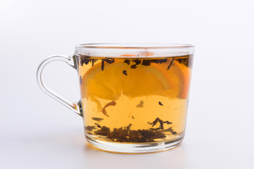 Glass cup of hot aromatic tea on white background