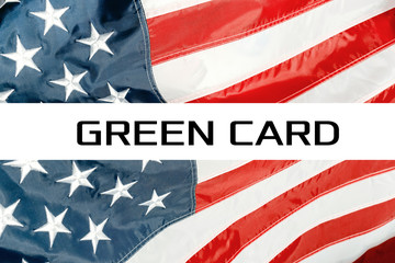 Green Card on a USA flag background. United States of America flag waving in the wind. Proud...