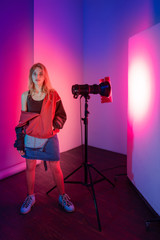Retro style fashionable woman in retro style on the neon light