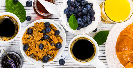 Continental Breakfast with croissants, coffee, cereals and fruits. Selective focus.