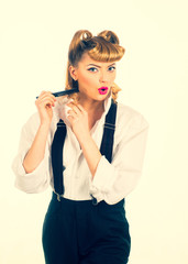 Hairstyle. Beauty saloon. The hairdresser. Girl with a comb and curls. Blonde, style for a young woman. Beautiful woman portrait. Woman combing her hair, looking at camera and smiling.