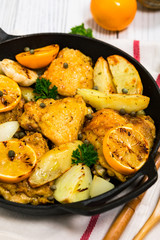 Chicken Thighs Roasted with Meyer Lemon and Potatoes. Selective focus.