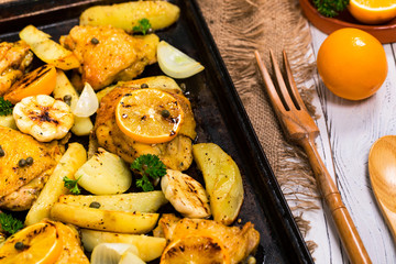 Chicken Thighs Roasted with Meyer Lemon and Potatoes. Selective focus.