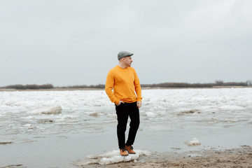 man's travels in a yellow sweater
