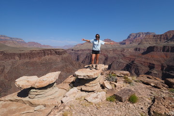 Young female backpacker enjoying a sweeping view of the canyon from the Tonto Trail in Grand Canyon National Park, Arizona.
