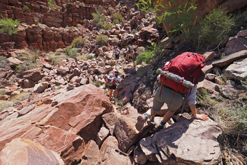 Backpackers descending the Tonto Trail in Mineral Canyon in Grand Canyon National Park, Arizona on a clear May morning.