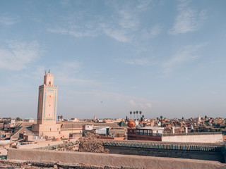 Fototapeta na wymiar A panorama view of the roofs of traditional houses of the Medina and of a Minaret in Marrakech.