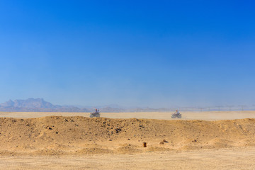 Fototapeta na wymiar People driving quad bikes during safari trip in Arabian desert not far from the Hurghada city, Egypt