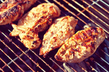 Grilled chicken breast on barbeque