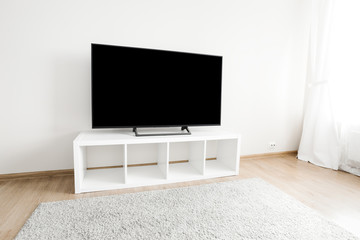 Lcd tv on white shef at living room interior