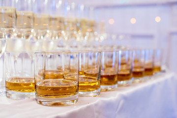 Alcoholic and non-alcoholic beverages. The party is just beginning. Rows of glasses with drinks.