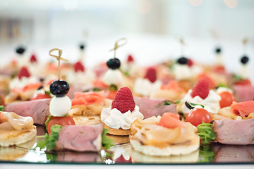 Beautiful table setting meal. Banquet. Red fish, canapes, food and snacks.