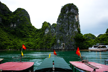 Vietnam Halong Bay ocean boats flag emerald mountain islands landscape nature travel vacation destination