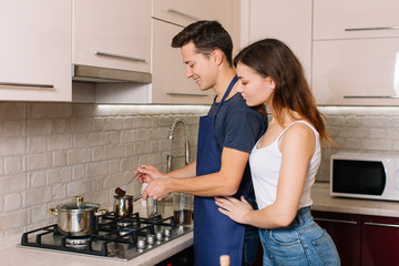 Couple cooking together in the kitchen at home