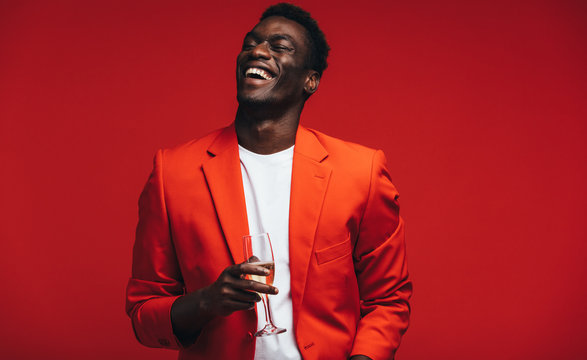 Smiling young guy having champagne