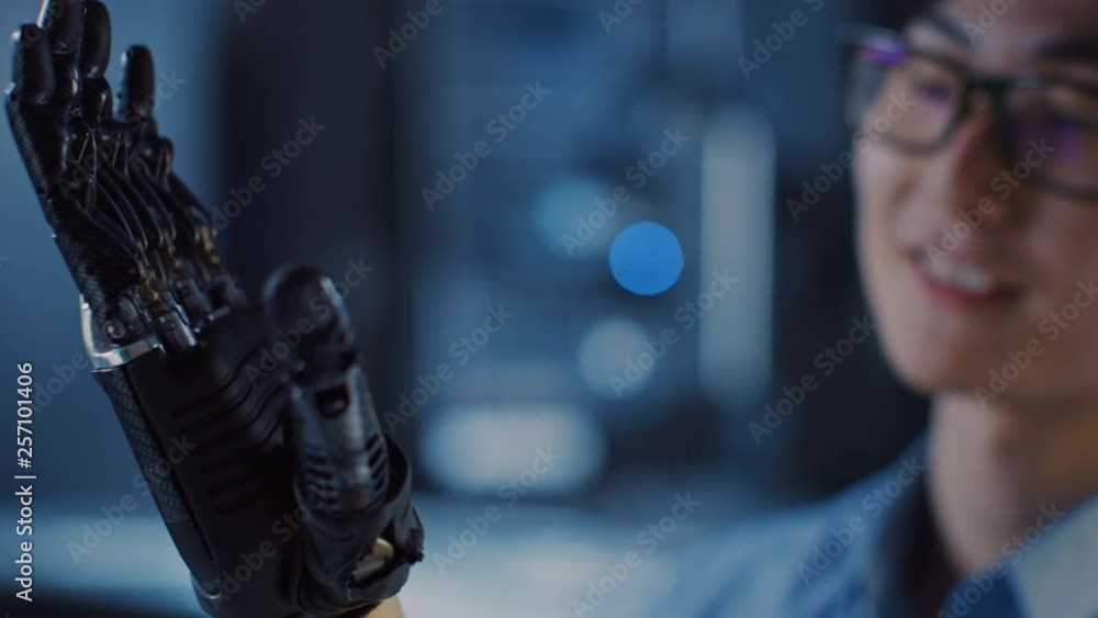 Aufkleber close up of a futuristic prosthetic robot arm being tested by a professional development engineer in