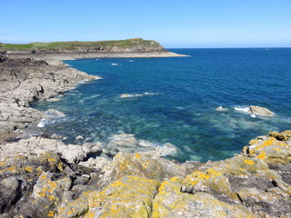 Côte rocheuse à Saint-Malo en Bretagne, mer bleue et vue sur la pointe de la Varde (France)