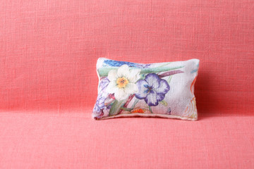 Flowered pillow on pink soda