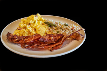 breakfast bacon and eggs with ham, rice beans, corn peas