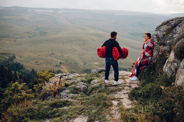 Fototapeta premium love story a guy and a girl in a tent in the mountains in nature