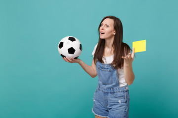 Bemused puzzled woman football fan support team with soccer ball, yellow card, propose player...