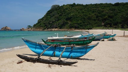 lonley beach with traditional old used fishing boats