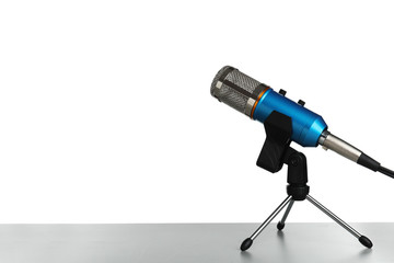 Microphone on table against white background. Space for text