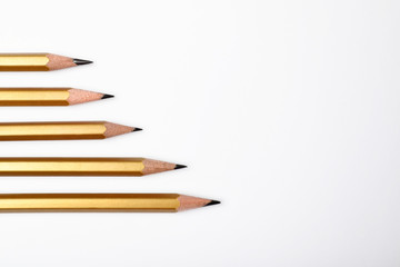 Fototapeta premium Pencils with longest one and space for text on white background, top view. Victory concept
