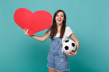 Cheerful young woman football fan cheer up support favorite team with soccer ball, empty blank red...
