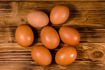 Pile of the hen eggs on wooden table. Top view