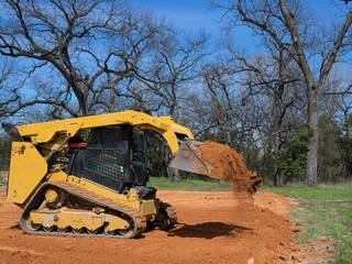 Skid Steer Loader Lifting Dirt